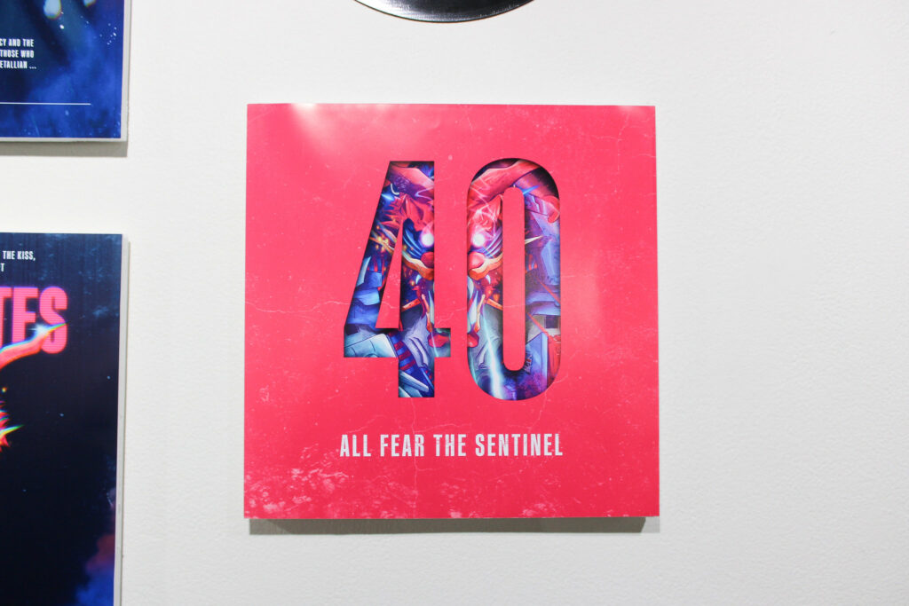 A custom record sleeve depicting a colorful dragon in the negative space of the number "40" with the words "all fear the sentinel" beneath it