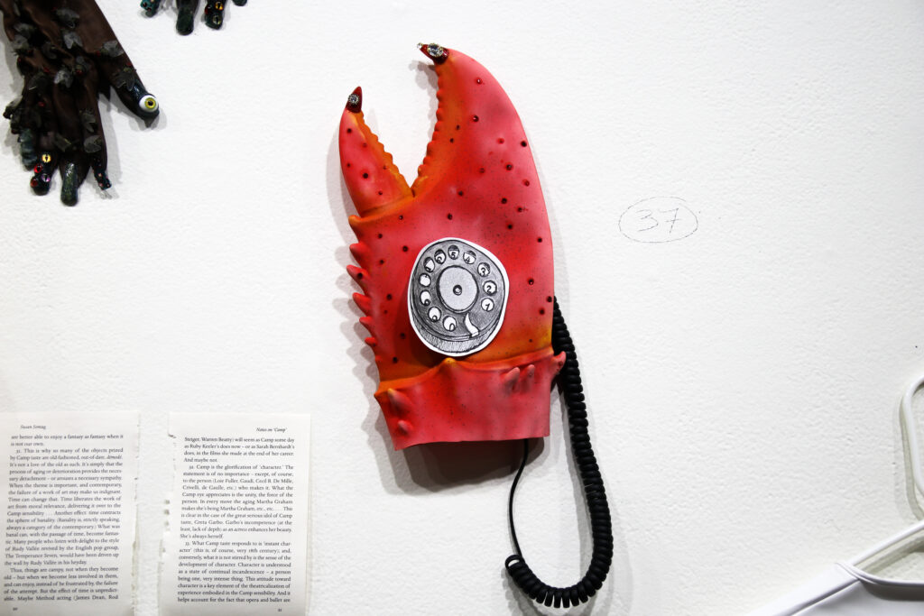 Glove shaped like a crab hand that that has telephone rotary design on top created by artist Kyle Angel