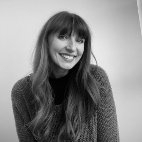 Woman with long hair smiling.