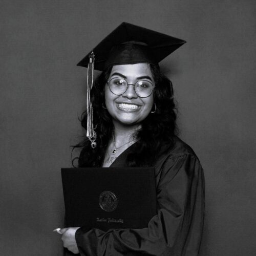 woman smiling in graduation cap and gown