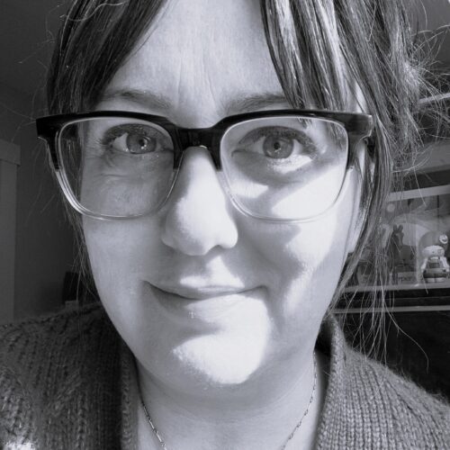 Woman in glasses and slight smile
